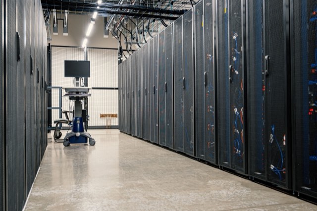 Overhead view of a technician in a data center aisle